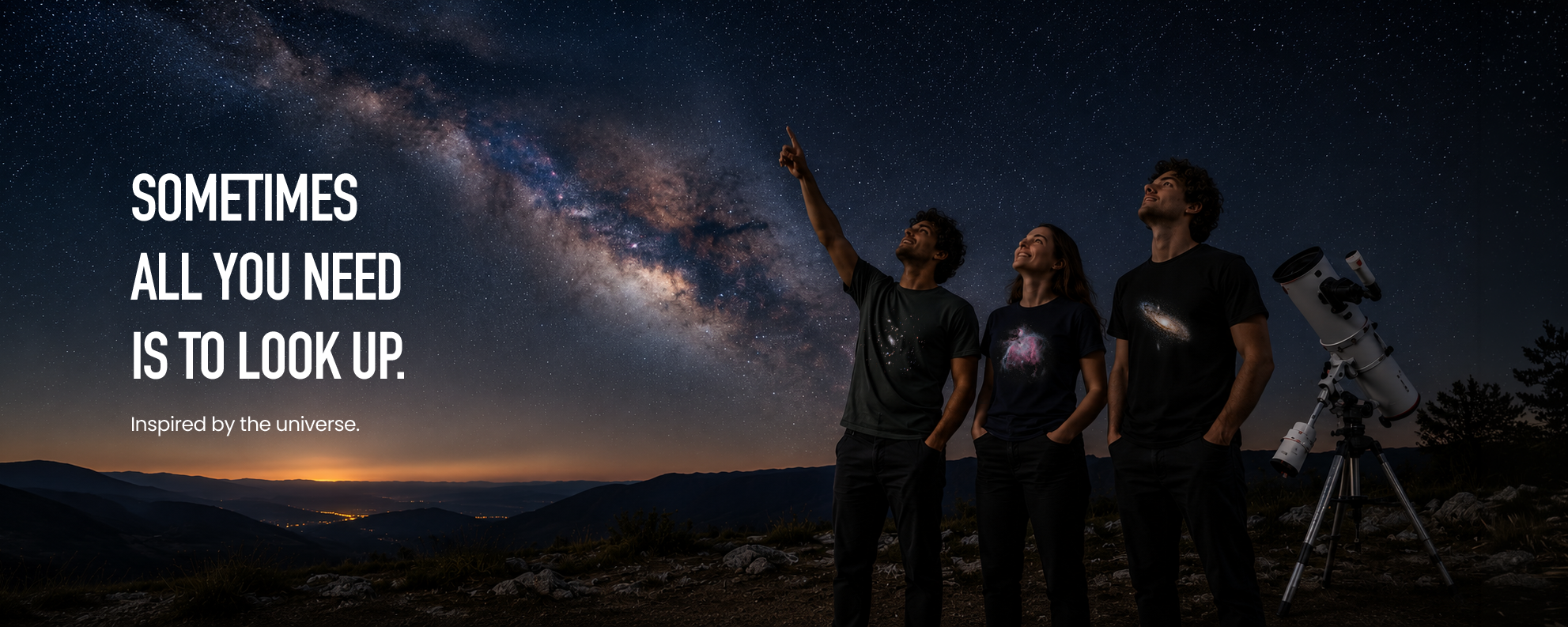 Three people standing outdoors at night under a starry sky and Milky Way, wearing matching dark T-shirts with a galaxy print. A telescope is visible on the right, and large text on the left reads, 'SOMETIMES ALL YOU NEED IS TO LOOK UP.